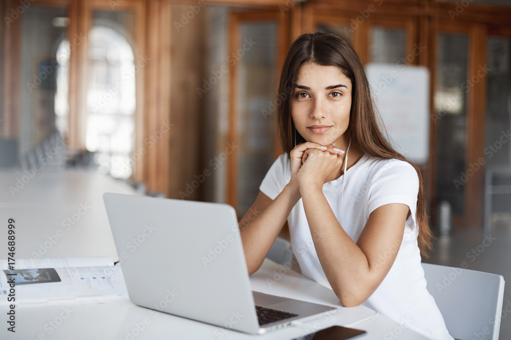 Portrait of young female student sitting in library studying. Future designer or lawyer finding her way in life. Education concept. Portrait of young female student sitting in library studying. Future designer or lawyer finding her way in life. Education concept.