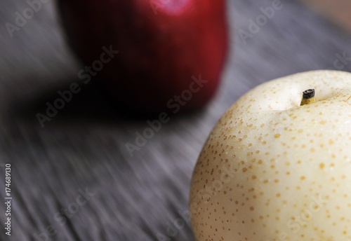 raw organic yellow Asian apple pear on wooden table photo
