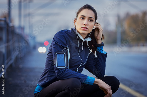 Woman take a break while jogging photo