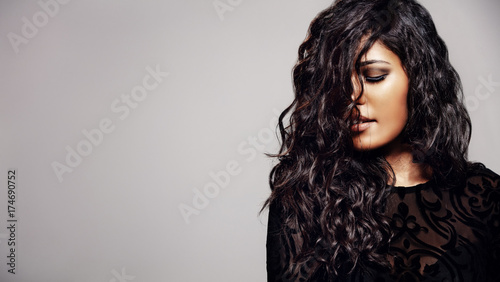 Sensual woman with shiny curly hair