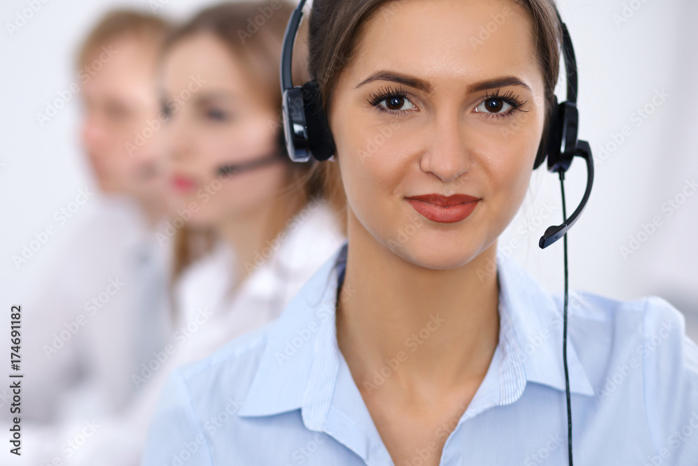 Call center. Focus on beautiful business woman in headset Call center. Focus on beautiful business woman in headset