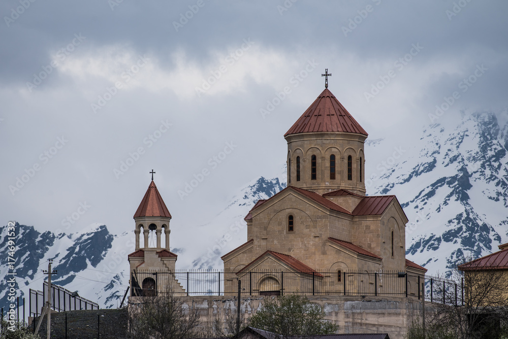 Georgian church with snowy mountains on the background in Mestia, Georgia