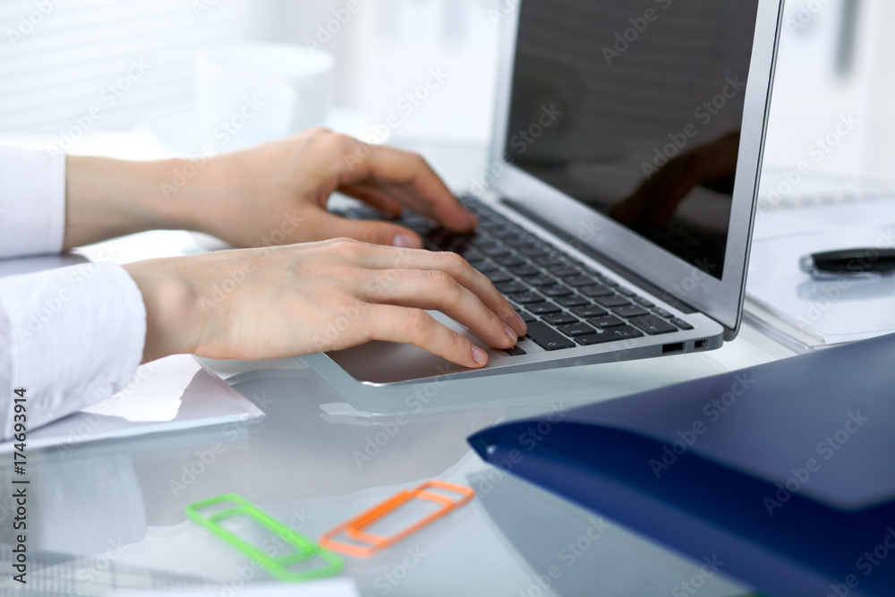 Close up of business woman hands typing on laptop computer Close up of business woman hands typing on laptop computer