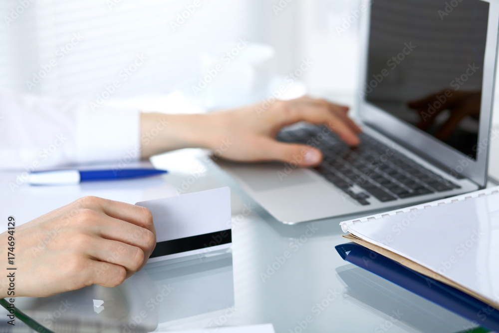 Close up of business woman hands typing on laptop computer