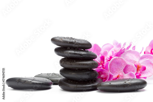 Spa stones and orchid flowers, isolated on white.