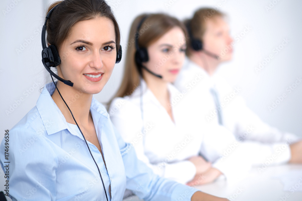 Call center. Focus on beautiful business woman in headset Call center. Focus on beautiful business woman in headset
