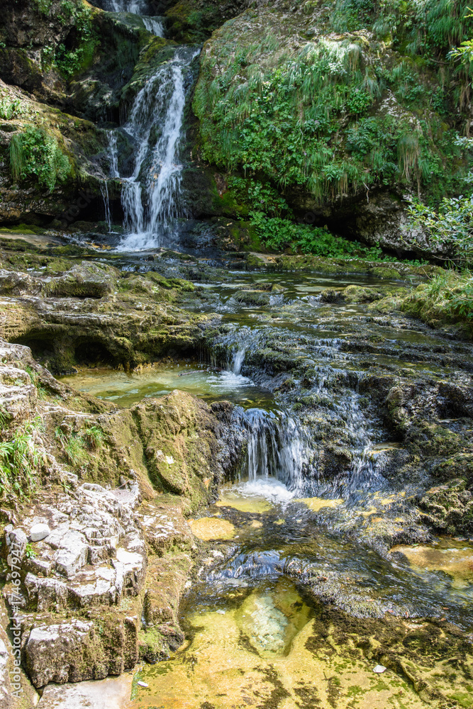 Dreamy waterfall and small emerald pond. Karst water. Fontanon of Goriuda. Friuli