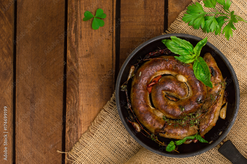 Homemade Pork Sausages in pan with thyme. Rustic wooden background. Close-up. Top view