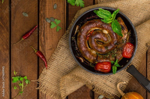 Homemade Pork Sausages in pan with thyme. Rustic wooden background. Close-up. Top view