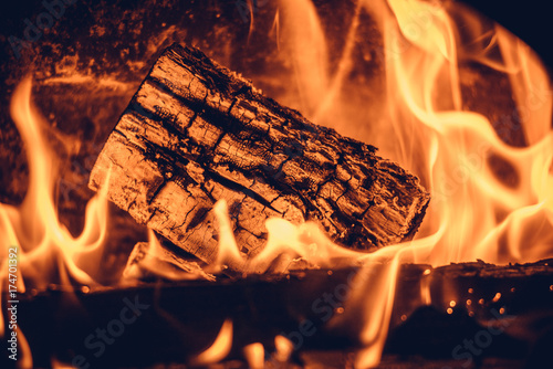 Wood in the flames of cozy fireplace