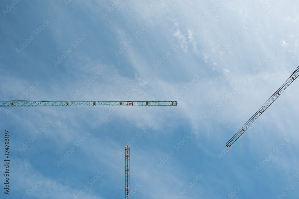 Three cranes detail over sky background. Three cranes detail over sky background.