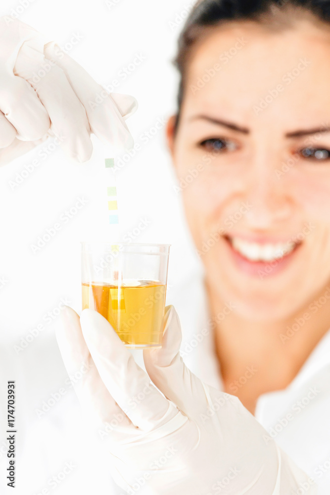 Medical worker testing urine sample Medical worker testing urine sample
