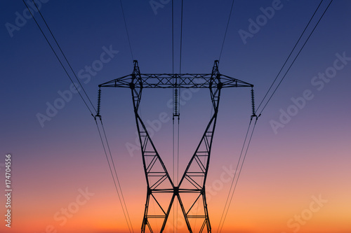 high voltage electricity tower silhouette at sunset