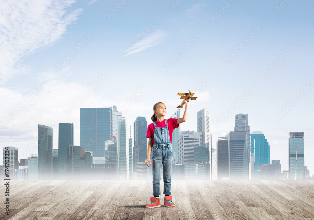 Concept of careless happy childhood with girl dreaming about future Concept of careless happy childhood with girl dreaming about future
