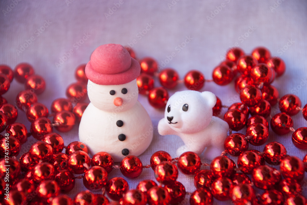 Figures of small white bear tree and Snowman with red garland. New year card. Merry christmas background. Xmas postcard.