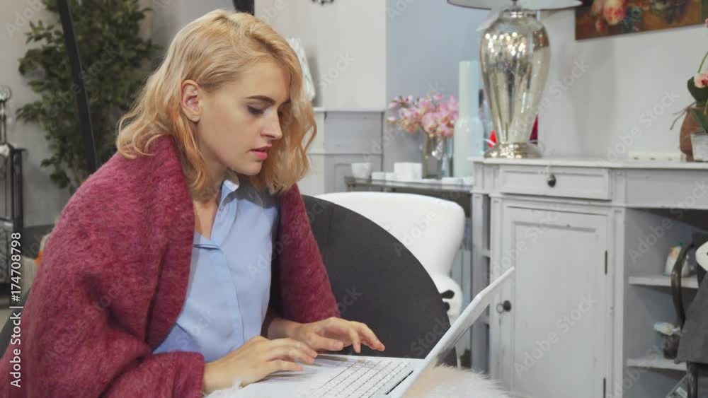 The girl is using her laptop. She is surfing the Internet and looking for something. Then she makes a video call. She waves her hand to greet someone The girl is using her laptop. She is surfing the Internet and looking for something. Then she makes a video call. She waves her hand to greet someone