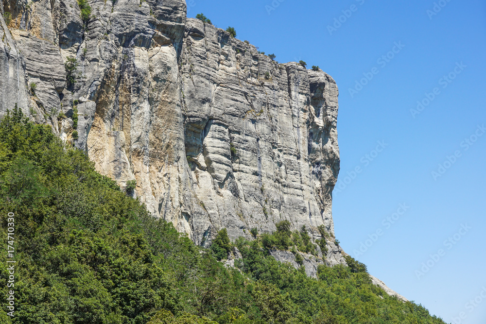 vertical mountain . Rock climbing the steep cliffs of the mountains .