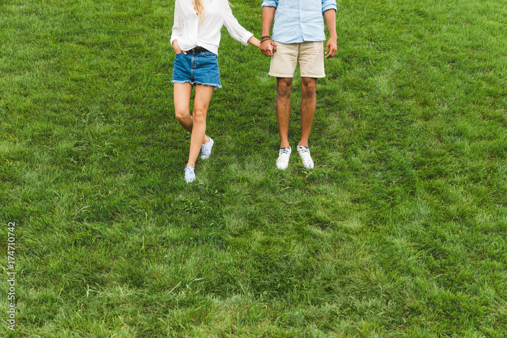 couple walking on green lawn