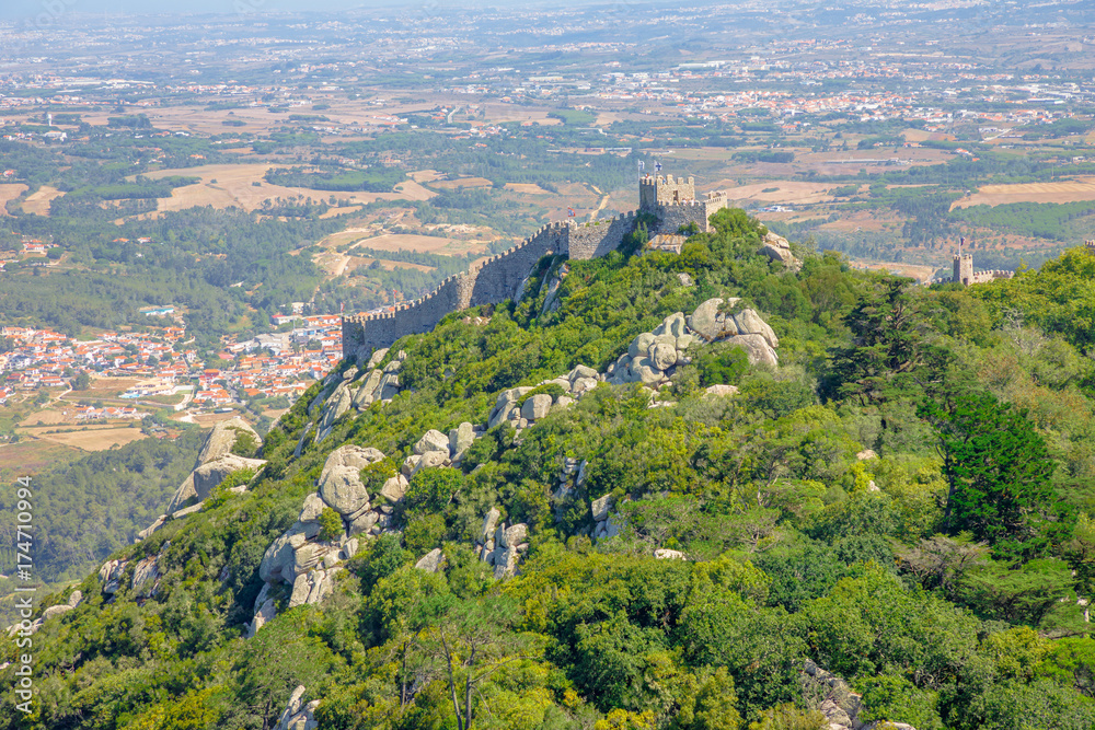 Aerial view of Castle of the Moors and Sintra valley from Pena National Palace. Moorish fortress or Castelo dos Mouros is medieval castle and Unesco Heritage on top of a hill above Sintra, Portugal.
