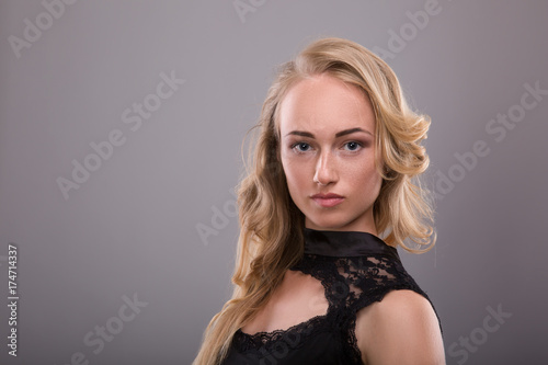 Sensual portrait of beautiful young blond woman with freckles