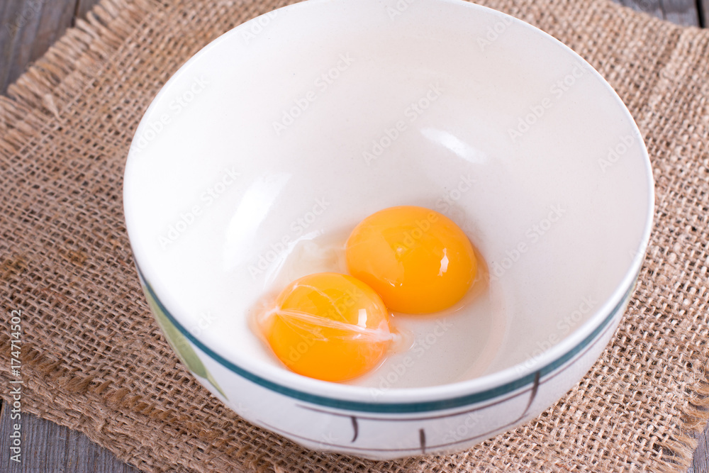 Raw yolks in a ceramic bowl Raw yolks in a ceramic bowl