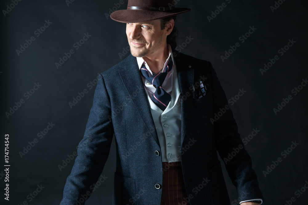 Young man portrait with hat on gray studio background. Young man portrait with hat on gray studio background.