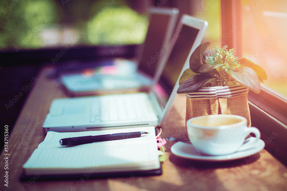 Pen and notebook with laptop.Inspiration moment,workspace or coffee break in the morning/ selective focus Pen and notebook with laptop.Inspiration moment,workspace or coffee break in the morning/ selective focus