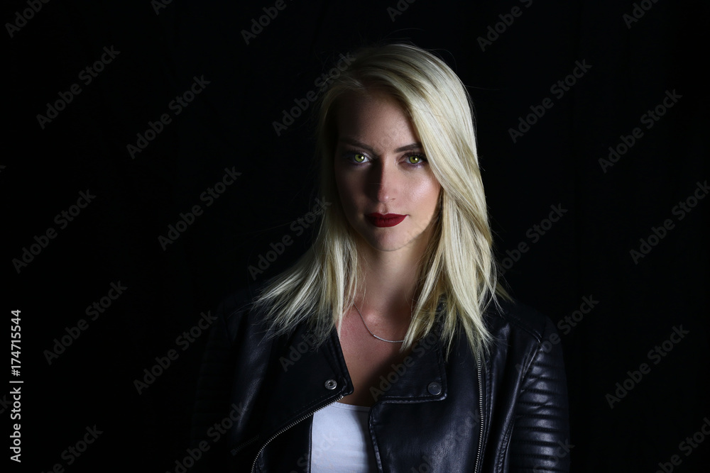 Beautiful vampire girl posing on a black background Beautiful vampire girl posing on a black background