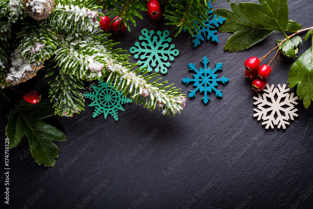 Background christmas decoration twig, red berries and wooden stars on back slate. Background christmas decoration twig, red berries and wooden stars on back slate.