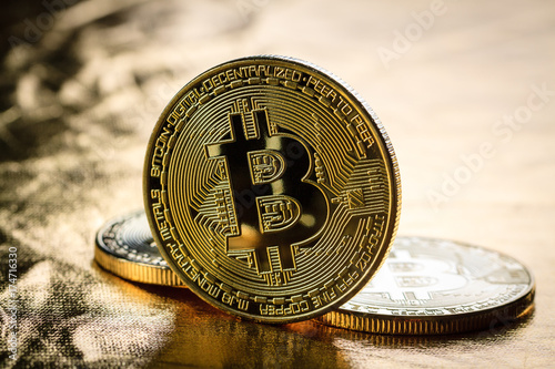 Bitcoin coins on gold colour background.
