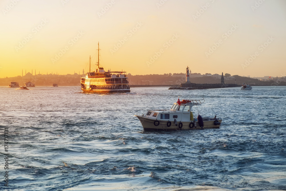 Evening Bosphorus sunset with boat ferry lighthouse Istanbul October