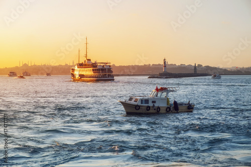 Evening Bosphorus sunset with boat ferry lighthouse Istanbul October © Margarita
