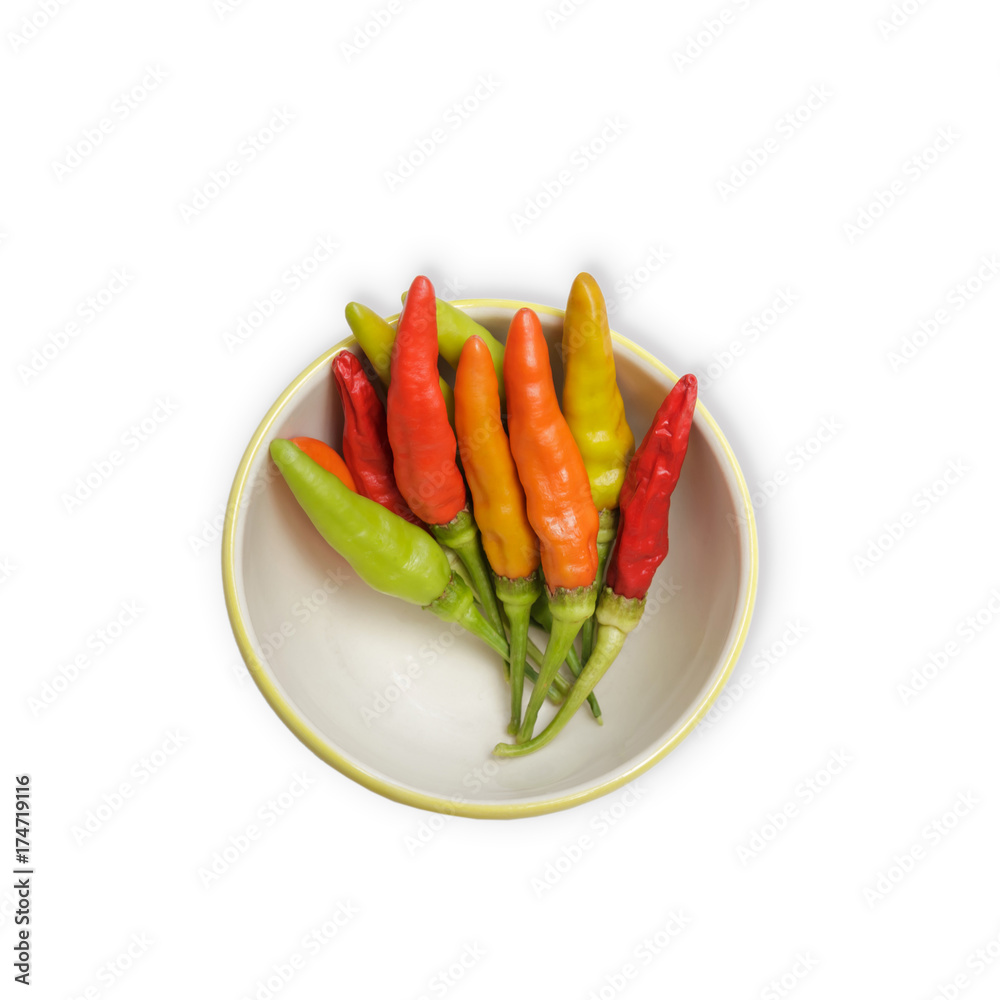Bowl of different colors of chilli peppers isolated on white background. Bowl of different colors of chilli peppers isolated on white background.
