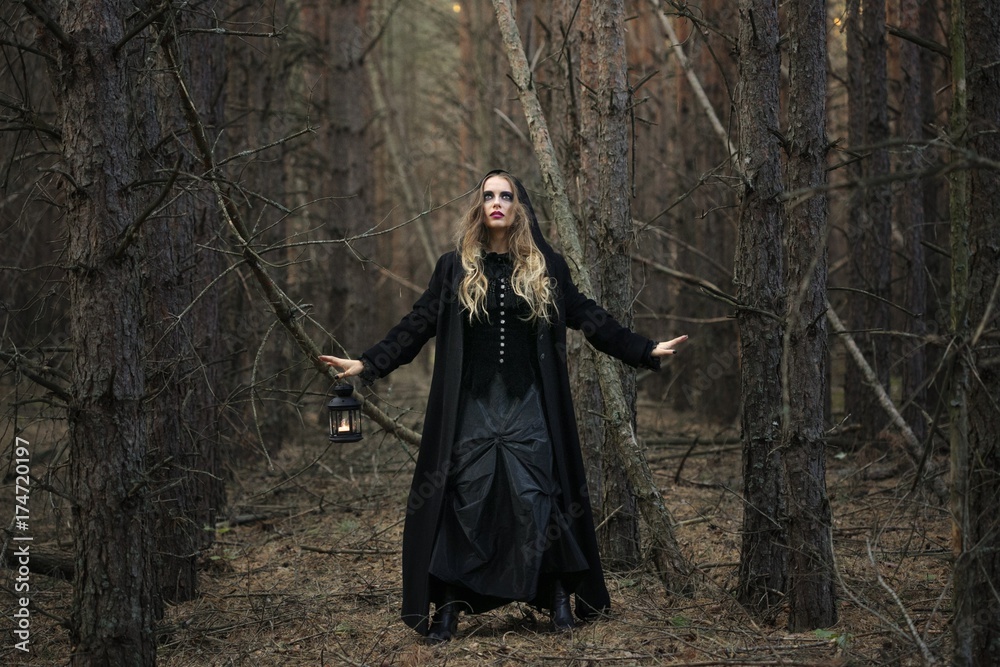 Halloween. beautiful girl with a lantern in a black dress in the forest. Halloween. beautiful girl with a lantern in a black dress in the forest.