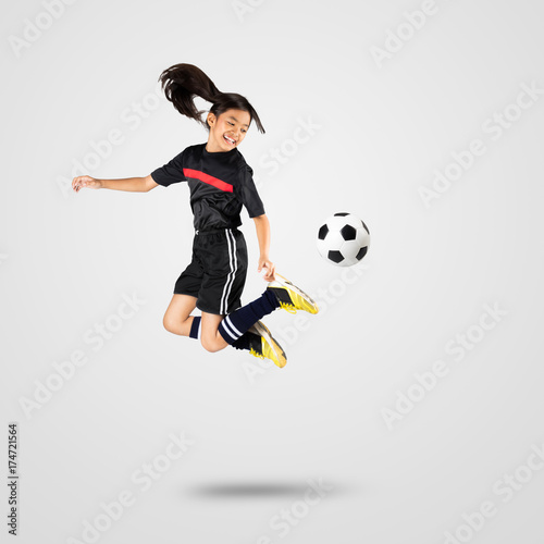 Young asian girl soccer player, Isolated on grey background © Patrick Foto
