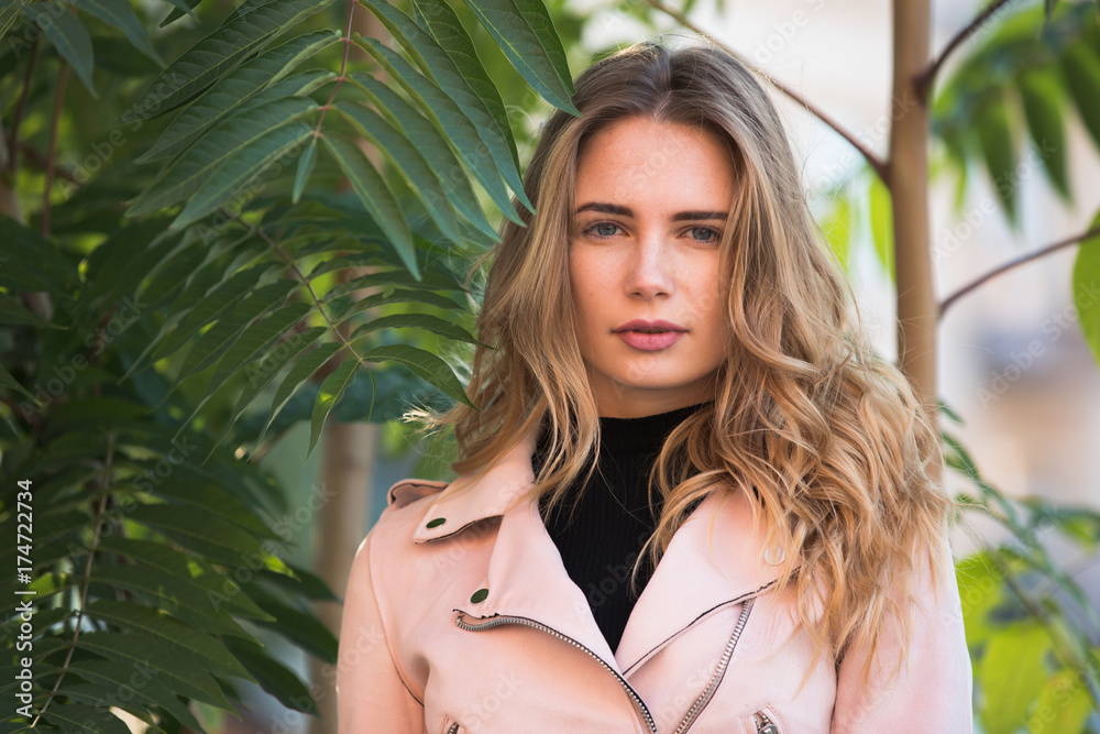 Autumn fashion. Stylish woman in jacket standing near beautiful green tree. Autumn fashion. Stylish woman in jacket standing near beautiful green tree.