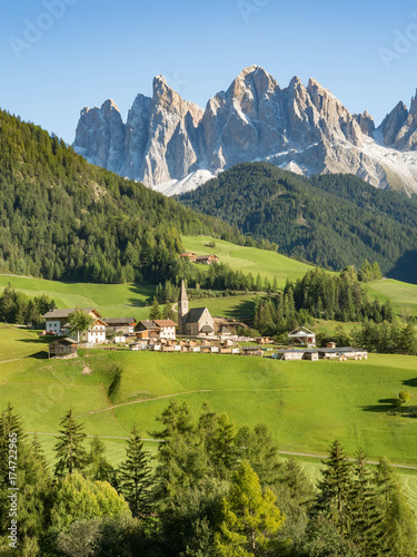 Colors of Dolomites. funes view of the valley, Puez-Odle in autumn. at sunset holy magdalena. View of odle mountain. Santa Maddalena, Tyrol, Italy. Green grass, mountains and blue sky. Summer