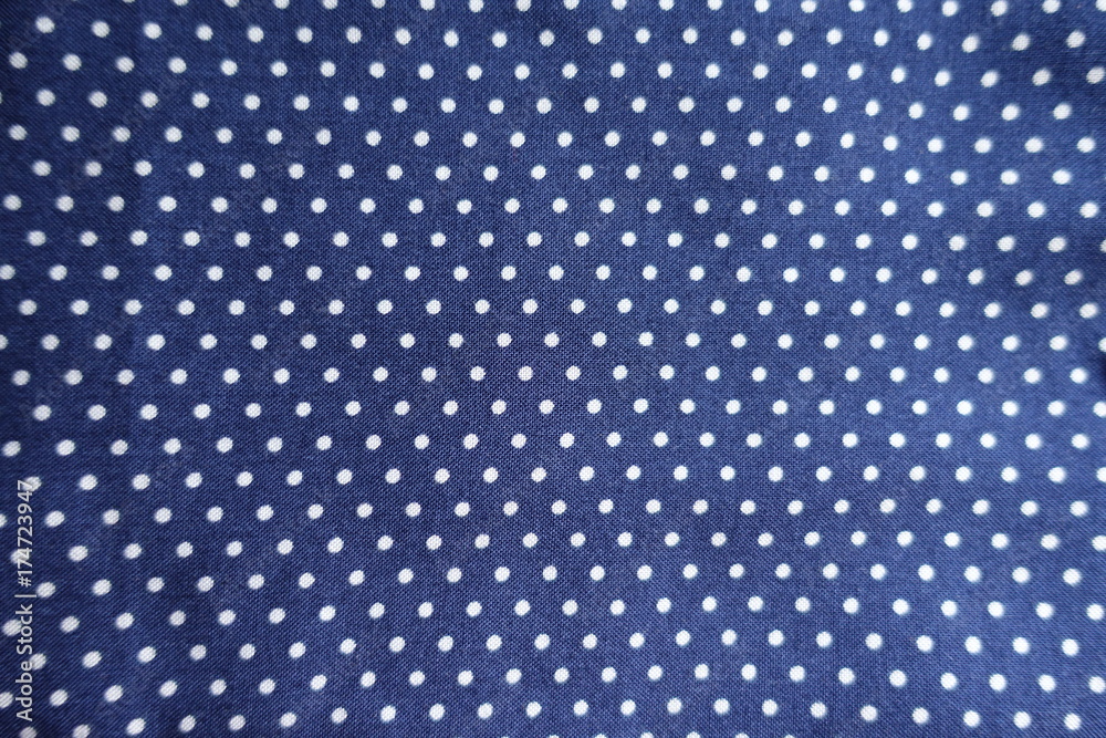 Surface of spotted blue fabric from above Surface of spotted blue fabric from above