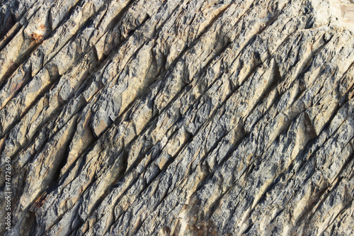 Photos texture of the stone with white veins. presumably shale rock.