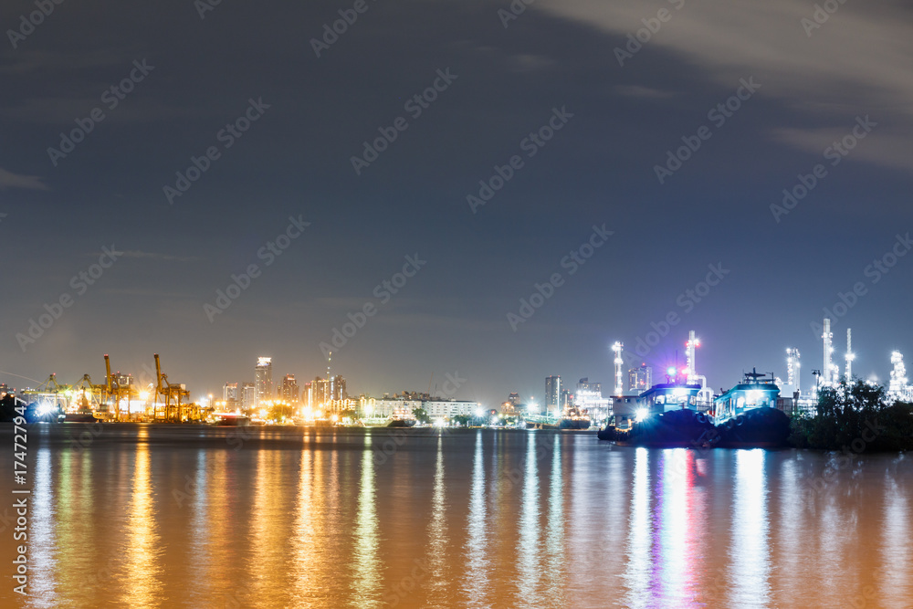 Commercial docks with light at  night with a ship and crane