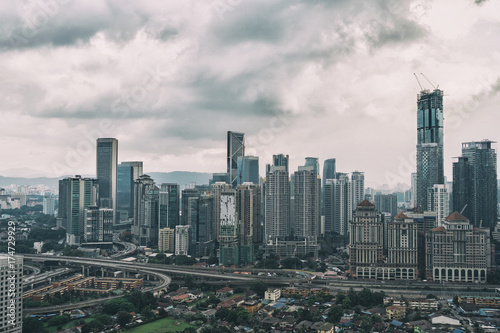 Cityscape with cloudy sky and scyscrapers. Megapolis Kuala-Lumpur, Malaysia.