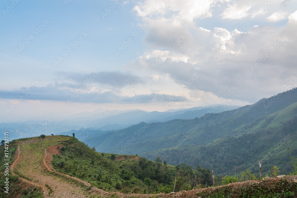 Scenery with mountain peaks and cloud mist on sky at Phou Khoun in Laos. evening time