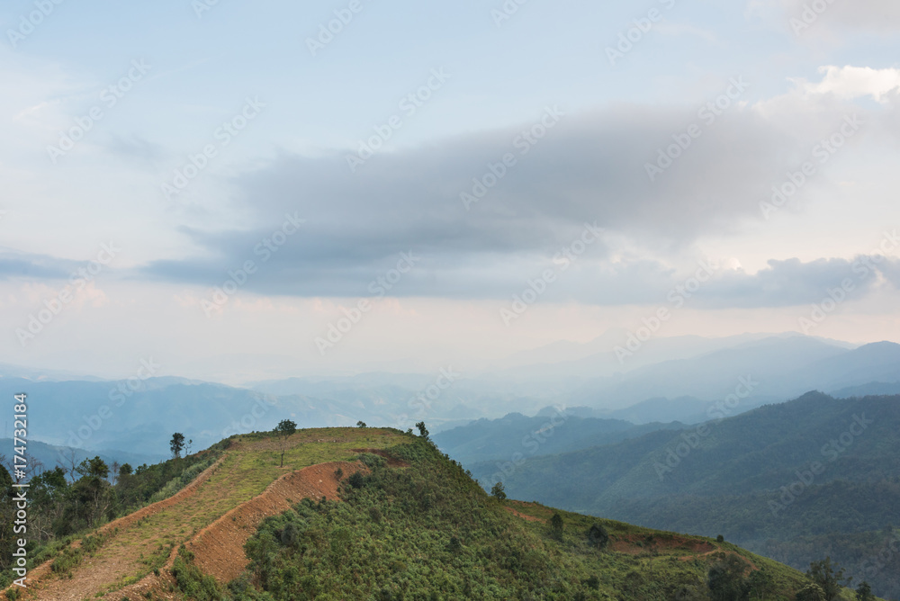 Scenery with mountain peaks and cloud mist on sky at Phou Khoun in Laos. evening time