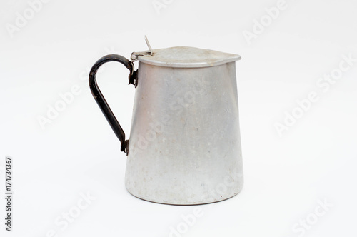 Aged tin kettle isolated