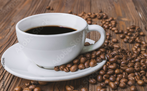 Black coffee and coffee bean on brown wooden table