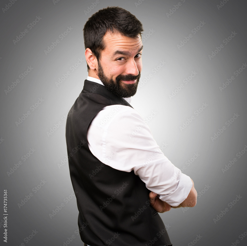Cool man with his arms crossed on grey background Cool man with his arms crossed on grey background