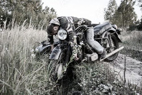 Drunk man in a motorcycle with a sidecar got stuck on the road in forest