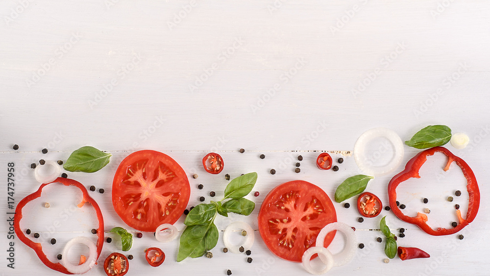 Fototapeta Vegetables background. Tomatoes, basil and garlic on white wooden table. Food background