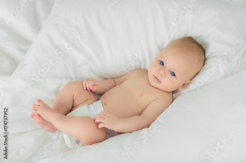Portrait of a child four months on bed