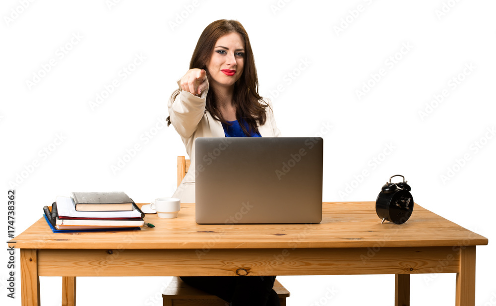 Business woman working with her laptop and pointing to the front Business woman working with her laptop and pointing to the front